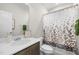 Bright bathroom with a shower-tub combo, single sink vanity, and decorative accents at 820 Laurel Gate Dr, Wake Forest, NC 27587