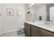 Bathroom featuring a double vanity, large mirror, framed art, and blue accents at 820 Laurel Gate Dr, Wake Forest, NC 27587