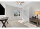Bright bedroom featuring neutral carpeting, a Murphy bed, ceiling fan, and desk for a comfortable and versatile space at 820 Laurel Gate Dr, Wake Forest, NC 27587