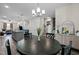 Bright dining area featuring a modern chandelier, round table with seating, and seamless flow to the living spaces at 820 Laurel Gate Dr, Wake Forest, NC 27587