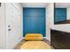 Inviting entryway featuring a decorative blue wall, storage bench, dresser and laminate flooring at 820 Laurel Gate Dr, Wake Forest, NC 27587