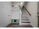 Functional mudroom with built-in storage, bench, and hooks leading to the staircase for seamless organization at 820 Laurel Gate Dr, Wake Forest, NC 27587