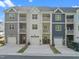 A row of stylish townhomes each featuring a garage and a balcony for residents to enjoy outdoor living at 820 Laurel Gate Dr, Wake Forest, NC 27587