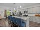 Modern kitchen island with seating, stainless steel appliances, and gray cabinets, perfect for cooking and dining at 820 Laurel Gate Dr, Wake Forest, NC 27587