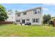 Spacious backyard featuring well-kept lawn, a concrete patio, and a two-story house with blue shutters at 8408 Haines Creek Ln, Raleigh, NC 27616