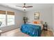 Comfortable bedroom with ceiling fan, natural light, and minimalist decor at 8408 Haines Creek Ln, Raleigh, NC 27616