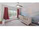 Charming Bedroom featuring a modern ceiling fan and an accent wall with calming mountain scenery at 8408 Haines Creek Ln, Raleigh, NC 27616