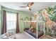 Themed bedroom with jungle mural, neutral carpet, ceiling fan, and curtains at 8408 Haines Creek Ln, Raleigh, NC 27616