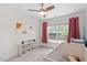 Bright Bedroom boasts natural light, a modern ceiling fan and curated artwork at 8408 Haines Creek Ln, Raleigh, NC 27616