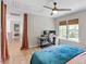 Upstairs bedroom with ceiling fan, workstation, and plenty of natural light from backyard at 8408 Haines Creek Ln, Raleigh, NC 27616