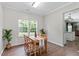 Bright dining room with hardwood floors, table and chairs and natural light from windows at 8408 Haines Creek Ln, Raleigh, NC 27616