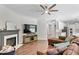 Open floorplan living room with fireplace, entertainment center, and sightlines into kitchen at 8408 Haines Creek Ln, Raleigh, NC 27616