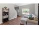 Cozy living room with hardwood floors, a comfortable sofa, and a bright window at 8408 Haines Creek Ln, Raleigh, NC 27616
