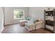 Comfortable living room with a plush sofa, natural light, and modern decor on hardwood floors at 8408 Haines Creek Ln, Raleigh, NC 27616