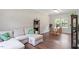Bright living room with a large sofa, modern shelving, and natural light from the windows at 8408 Haines Creek Ln, Raleigh, NC 27616