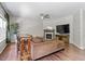 Cozy living room featuring a fireplace, ceiling fan, and bar seating with plenty of natural light at 8408 Haines Creek Ln, Raleigh, NC 27616