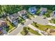 Aerial view of suburban homes showcasing well-manicured lawns and tree-lined streets on a sunny day at 846 Lake Artesia Ln, Fuquay Varina, NC 27526