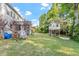 Spacious backyard with lush lawn, mature trees, and a charming playhouse, perfect for outdoor fun at 846 Lake Artesia Ln, Fuquay Varina, NC 27526