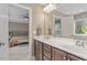 Bathroom featuring double sinks with modern fixtures, adjacent to a bedroom at 846 Lake Artesia Ln, Fuquay Varina, NC 27526