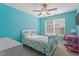 Bright bedroom features a ceiling fan, large window, and a colorful polka-dot bedspread at 846 Lake Artesia Ln, Fuquay Varina, NC 27526