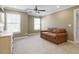 Large bonus room features neutral carpet, a ceiling fan, and lots of natural light at 846 Lake Artesia Ln, Fuquay Varina, NC 27526
