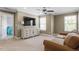 Bright bonus room features neutral carpet, a ceiling fan, and lots of natural light at 846 Lake Artesia Ln, Fuquay Varina, NC 27526