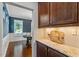 View of dining area from kitchen with granite countertop, wood cabinets, and hardwood floors at 846 Lake Artesia Ln, Fuquay Varina, NC 27526