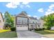 Charming two-story home boasts manicured lawn and a two-car garage at 846 Lake Artesia Ln, Fuquay Varina, NC 27526