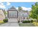 Charming two-story home boasts manicured lawn and a two-car garage at 846 Lake Artesia Ln, Fuquay Varina, NC 27526