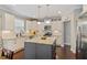 Contemporary kitchen featuring granite countertops, stainless steel appliances, island, and white cabinets at 846 Lake Artesia Ln, Fuquay Varina, NC 27526
