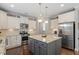 Modern kitchen features granite countertops, stainless steel appliances, white cabinets, and a central island at 846 Lake Artesia Ln, Fuquay Varina, NC 27526