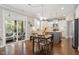 Eat-in kitchen with island, hardwood floors, sliding doors to screened porch, and stainless appliances at 846 Lake Artesia Ln, Fuquay Varina, NC 27526