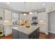 Stylish kitchen with granite countertops, stainless steel appliances, white cabinets, and central island at 846 Lake Artesia Ln, Fuquay Varina, NC 27526