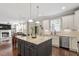 Open-concept kitchen with granite countertops, stainless steel appliances, white cabinets, and island at 846 Lake Artesia Ln, Fuquay Varina, NC 27526