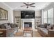 Bright living room features a fireplace, comfortable sofas, and neutral decor at 846 Lake Artesia Ln, Fuquay Varina, NC 27526