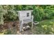 Backyard playhouse with climbing wall, sun deck, white trim, and room to relax under shady trees at 846 Lake Artesia Ln, Fuquay Varina, NC 27526