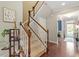 Elegant staircase with wood railings and neutral carpet leads to the upper level at 846 Lake Artesia Ln, Fuquay Varina, NC 27526