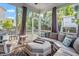 Cozy screened porch furnished with cushioned seating and an ottoman, perfect for relaxation at 846 Lake Artesia Ln, Fuquay Varina, NC 27526