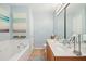 Bathroom featuring dual sinks, large mirrors, and lovely decor at 8640 Neuse Landing Ln # 110, Raleigh, NC 27616
