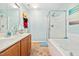 Bathroom featuring dual sinks, a tub, and a shower at 8640 Neuse Landing Ln # 110, Raleigh, NC 27616