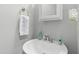 Cozy bathroom with modern sink, brushed nickel faucet, framed mirror, and decorative wall sconce at 8640 Neuse Landing Ln # 110, Raleigh, NC 27616