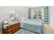 Inviting bedroom with a large window, plush bedding, and cozy decor at 8640 Neuse Landing Ln # 110, Raleigh, NC 27616
