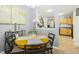 Warm dining room featuring a wooden table, seating for four, and a view into the adjacent kitchen at 8640 Neuse Landing Ln # 110, Raleigh, NC 27616