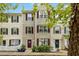 Charming townhome features a classic exterior with a picket fence and well-maintained landscaping at 8640 Neuse Landing Ln # 110, Raleigh, NC 27616