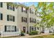 Inviting townhouse with colorful front doors, surrounded by well-kept garden beds and a picket fence at 8640 Neuse Landing Ln # 110, Raleigh, NC 27616