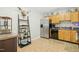 Efficient kitchen with stainless steel appliances, wooden cabinets, and a decorative ladder shelf at 8640 Neuse Landing Ln # 110, Raleigh, NC 27616