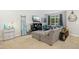 Comfortable living room featuring a sectional sofa, decorative pillows, and a window view at 8640 Neuse Landing Ln # 110, Raleigh, NC 27616