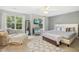 Bright main bedroom featuring neutral walls, large windows, and a comfortable bench at 8640 Neuse Landing Ln # 110, Raleigh, NC 27616