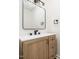 Bathroom with wood vanity, a rectangular mirror, and fixtures, offering style and functionality at 8731 Raleigh, Benson, NC 27504