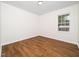 Cozy bedroom with hardwood floors and a window providing natural light to the space at 8731 Raleigh, Benson, NC 27504
